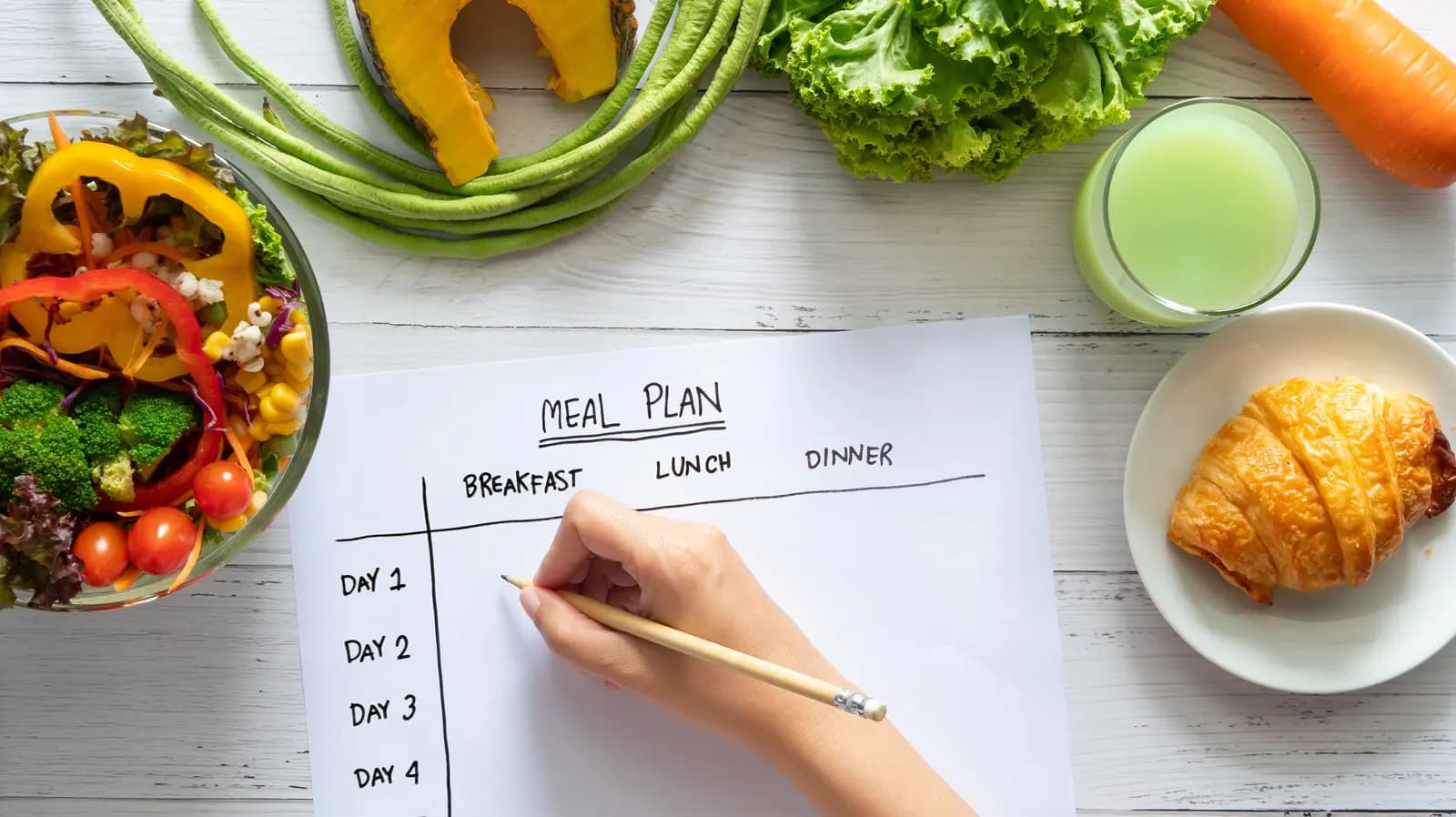 Pregnant woman preparing a colorful, nutritious meal in her kitchen