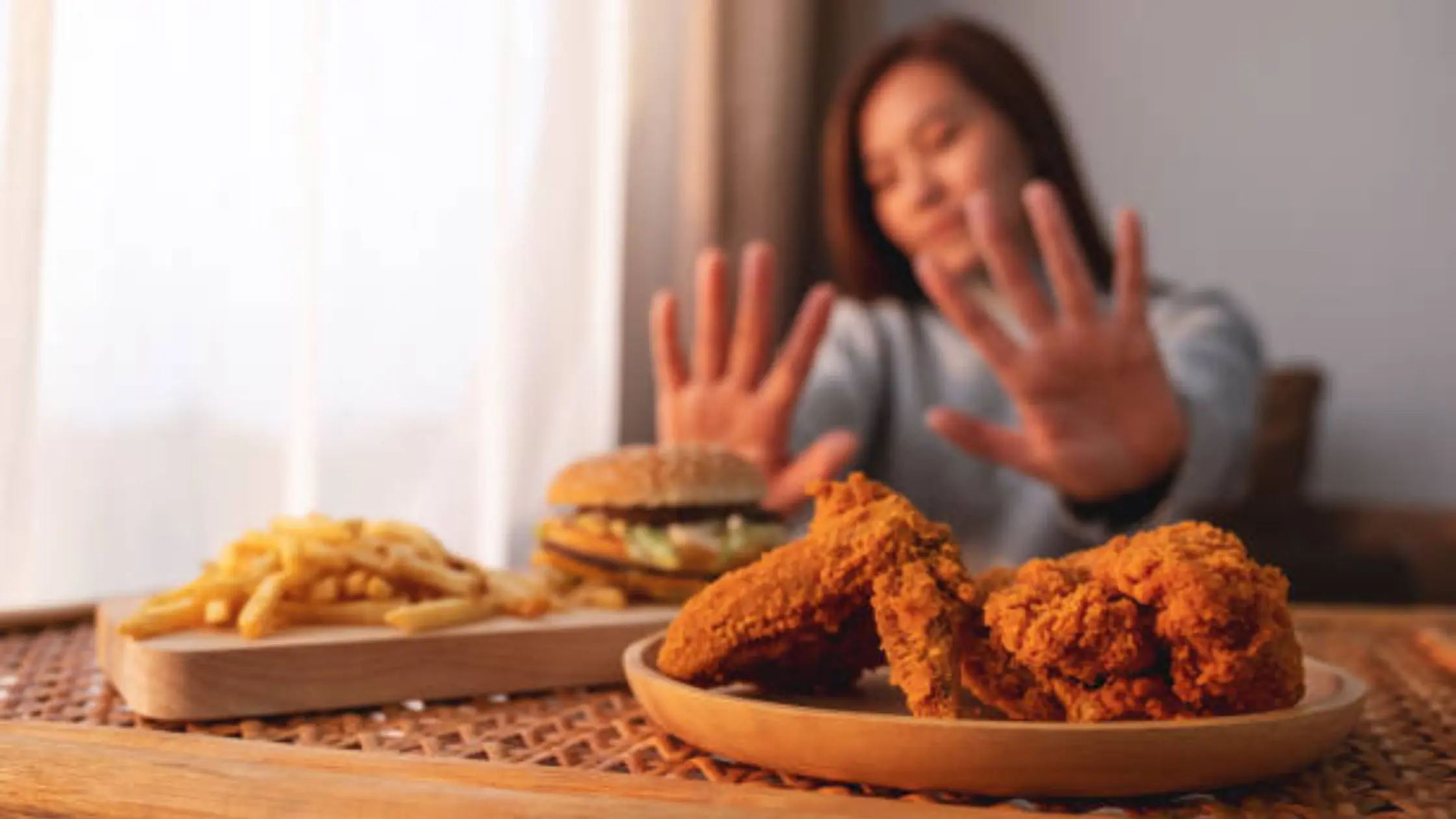 A pregnant woman looking at various food options.