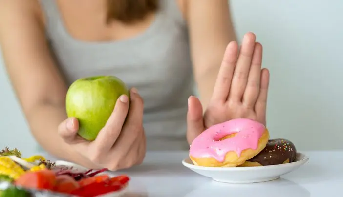 A pregnant woman avoiding certain foods.